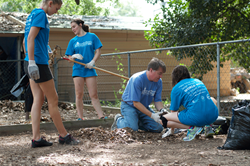 Centenary President David Rowe and students work during World House Service Day