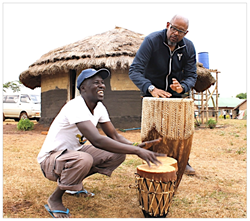 Okello Sam and Forest Whitaker – who met on the set of "The Last King Of Scotland" – practice on Ngoma drums in Uganda this summer. Whitaker is the honoree at Hope North's gala in NYC on Nov. 1.