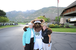 Gail Miller (l-r), the Jazz Bear and Salt Lake Community College President Deneece G. Huftalin pose before play begins.