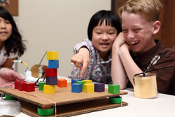 Students use a shake table to simulate earthquake effects.