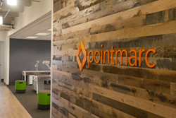 Pointmarc's new entrance features reclaimed wood walls and a sneak peek of the new branding.
