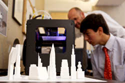 Allan Arp and Nathaniel Bayona ’14 examine one of The Hun School’s 3D printers.
