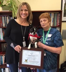 Therapy dog, Kona, receives winner certificate from Pets Best.