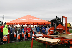 Students from North Decatur High School witness a live Wood-Mizer portable sawmill demonstration during their facility visit.