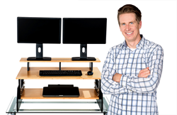 Zerwas is shown here standing (of course) next to one of his sleek new StandingDeskToppers which converts any regular desk into an ergonomically correct standing desk.