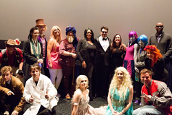 Cosplayers featured in "Cosplay Dreams 3D" gathered in front of the big screen