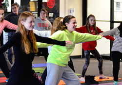 Hun Middle School students engaged in yoga during their mid-term examination preparations, in which they practiced breathing techniques and stretching to help calm their minds.