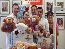 SmileCare orthodontist Dr. Geoffrey Kopecky (back row, left) and team members from 8 offices donated teddy bears to benefit Rady Children's Hospital.