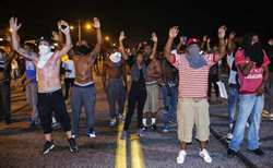 Photo showing protesters using the Hands Up gesture in Ferguson, Missouri, August 2014, from http://interoccupy.net/blog/hands-up-dont-shoot-demands/