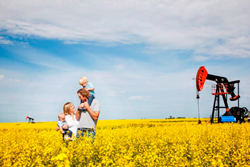 Family in-front of the Municipalities two main industries, Agriculture and Oil
