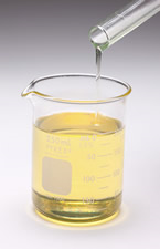 yellow liquid in a lipped glass beaker