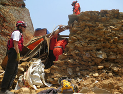 Los Topos and CINAT members enter the significantly damaged temple in Kathmandu on May 24 on an operation to salvage precious artifacts trapped beneath the structure’s collapsing roof.