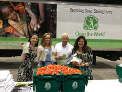 IMN Solutions employees Stephanie Zboznovits, Kristin Geiger,  Lawson Hockman, and Irene Angelos, show off the hygiene kits they put together to support the Clean The World Organization at the AWEA WINDPOWER 2015 Conference & Expo.