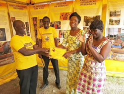 New group leader (left) hands a certificate to a woman who completed Volunteer Ministers course.