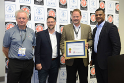 ROUSH Performance’s Paul Grant, Tony Marszalek and Tim Wheeler accept the Export Achievement Certificate from Commerce Department Assistant Secretary Marcus Jadotte.