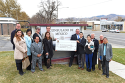 Mexican Consul Edwardo Arnal (left, holding check) poses with Salt Lake Community College staff and students at the Mexican Consulate in Salt Lake City.