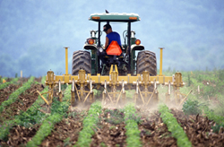 New report warns of climate change threats to food security - farmer tilling soil