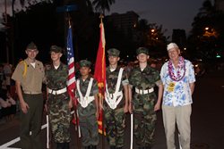 Young Marines lead the Pearl Harbor Memorial Parade in Honolulu with Mr. Tom Berg, a Pearl Harbor survivor who was 19 years old in 1941.
