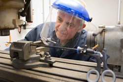 An AED technician inspecting a forcep.
