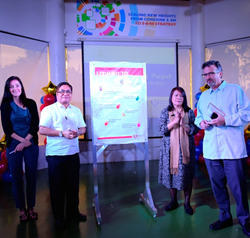 Leaders from CARD MRI, Freedom from Hunger, and the Microcredit Summit Campaign sign the Commitment wall