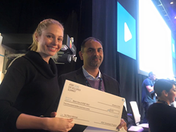 Sarah Austin accepts check on behalf of the team.