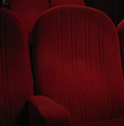 Dinner cinemas offer delicious menu items as patrons watch movies in plush, comfortble seating.