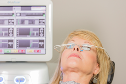 A woman with the LipiFlow® treatment device, The Activator, placed over her eyes