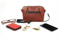 The Abby iPhone Case—mahogany naturally-pebbled leather with sample contents