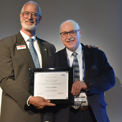 SPIE President Robert Lieberman, at left, presents Valery Tuchin with the 2016 Joseph W. Goodman Book Writing Award during SPIE Photonics Europe.