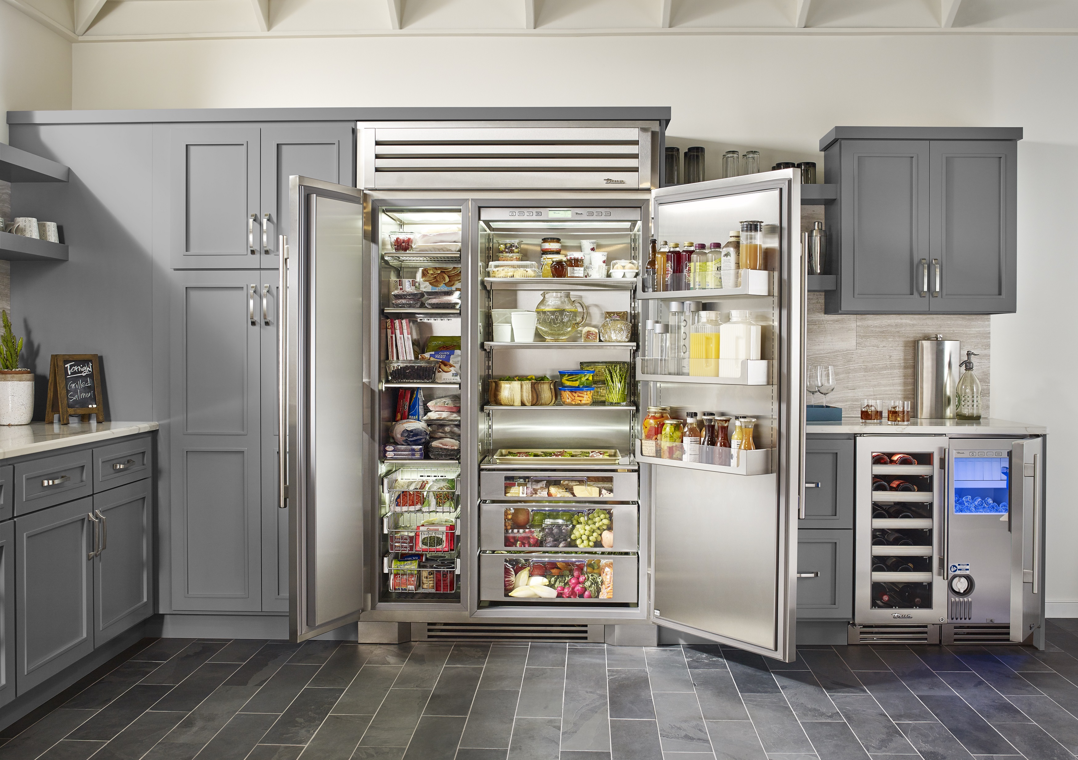 commercial kitchen sink near refrigerator