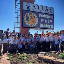 After planting more than 50 xeric (low water) plants together, the two groups posed for a photo by the garden.