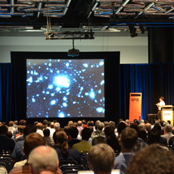 Plenary talks by institute directors, senior scientists, and other leading researchers are among highlights; above, 2016 symposium chair Masanori Iye, NAOJ, presents at the 2014 event in Montréal.