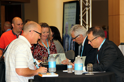 Robert J. Marzano and Michael D. Toth sign books at the Building Expertise education conference.