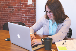 Woman on laptop with high stress and cravings