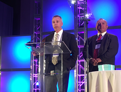 Kevin Morgan, president and CEO of ProLiteracy, and Jose Cruz, ProLiteracy board member, accepting the book signing donation at the 2016 Romance Writers of America conference in San Diego, California.