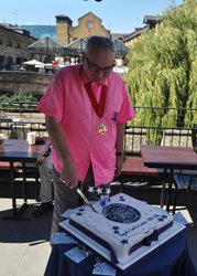 Deputy Mayor cuts cake with original crest on it