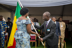 Mercy Ships volunteer Emmanuel Essah, from Benin presented the flag of his country to the First Lady of Benin upon arrival when she visited the floating hospital.