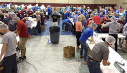 Volunteers pack meals for hungry children during Henderson Impact.
