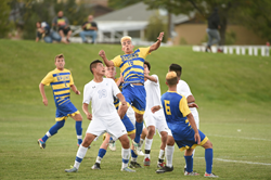 Matias Castano (center) jumps for a header.