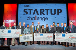 Winners and judges display some of their prizes after the 2016 SPIE Startup Challenge.