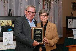 Dennis Ducharme, the 2015 recipient of the Eileen Rice Outstanding Business Leader of the Year Award presents Muffy Copenhaver with the 2016 award.