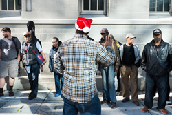 James Robinson of Swords to Plowshares greets veterans at the Holiday Luncheon.