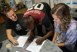 Mo and Alisha Charlo sign a Ziggi's Coffee franchise agreement with Brandon Knudsen, founder of the Colorado-based company.