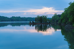 Photo of Melton Lake, near Oak Ridge, Tennessee, which is calm and glass-like.
