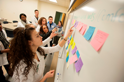 Students work in teams to develop interdisciplinary health plans for a patient as part of Husson University's Interprofessional Evening of Conversation.