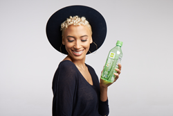 Andy Allo holds a bottle of ALO Exposed