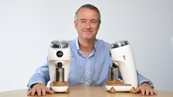 Martin Nicholson designer and CEO of Niche Coffee holds two Niche Zero grinders, designed to be the best coffee grinder.