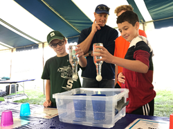 School-aged children with parent and science experiment.