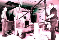 Two engineers working with an industrial pulsed laser system