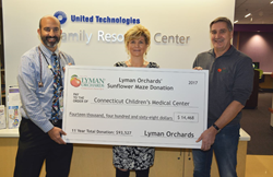 John Lyman delivers check to Connecticut Children's Medical Center